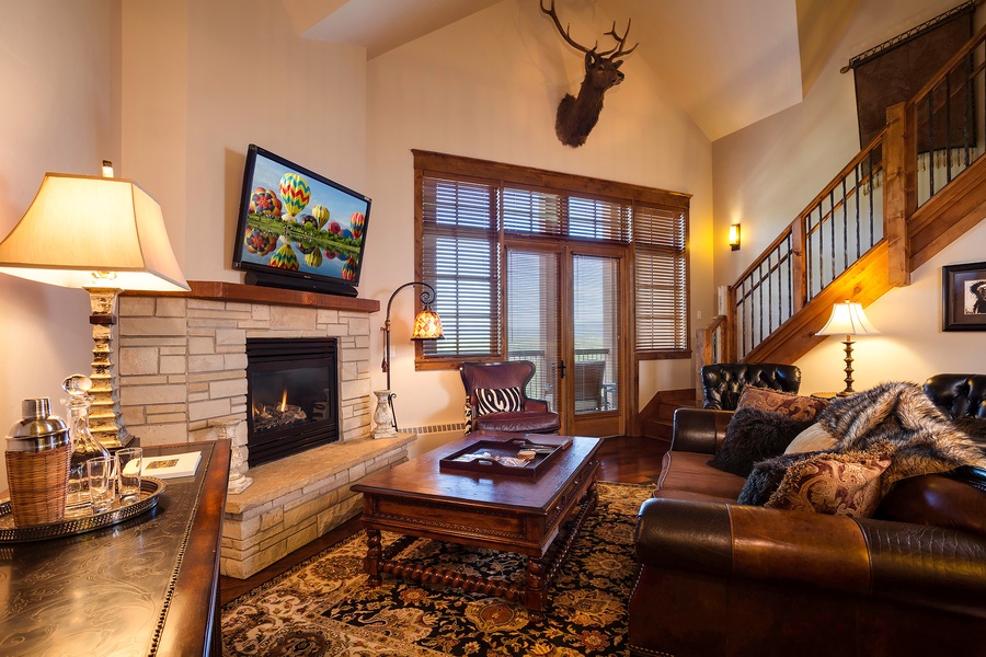 Sink into plush leather sofas by the stone fireplace while your favorite shows light up the flat-screen. Warm wood tones, cathedral ceilings, and mountain-lodge charm make this your perfect home away from home.