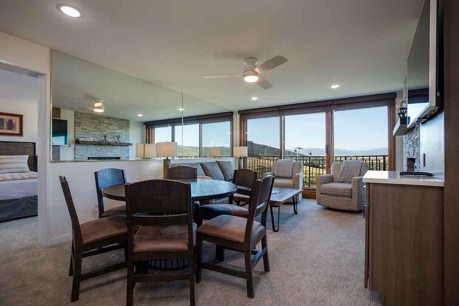 Floor-to-ceiling windows frame sweeping mountain vistas in this open-concept living space, where your dining and lounge areas flow seamlessly together, inviting relaxation and connection with nature's grandeur outside.