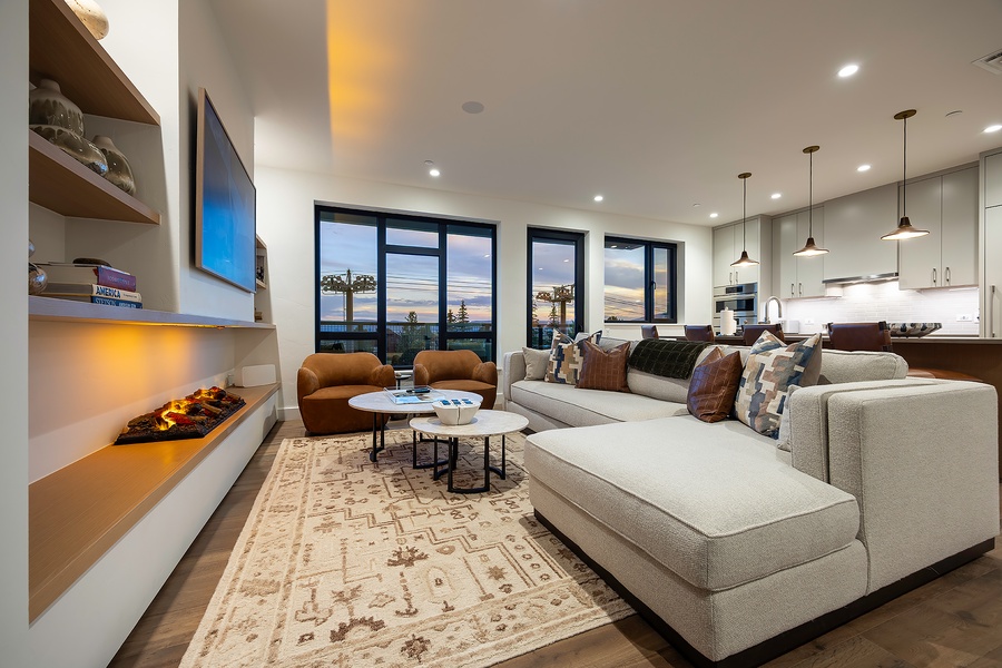 Sink into plush seating and take in the stunning sunset views. Your open-plan living space flows seamlessly into a modern kitchen, perfect for entertaining or quiet evenings in.