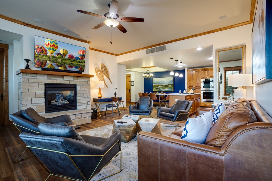 Gather with loved ones in this spacious living area featuring a cozy fireplace, plush leather seating, and warm wood accents that invite you to relax and feel right at home.