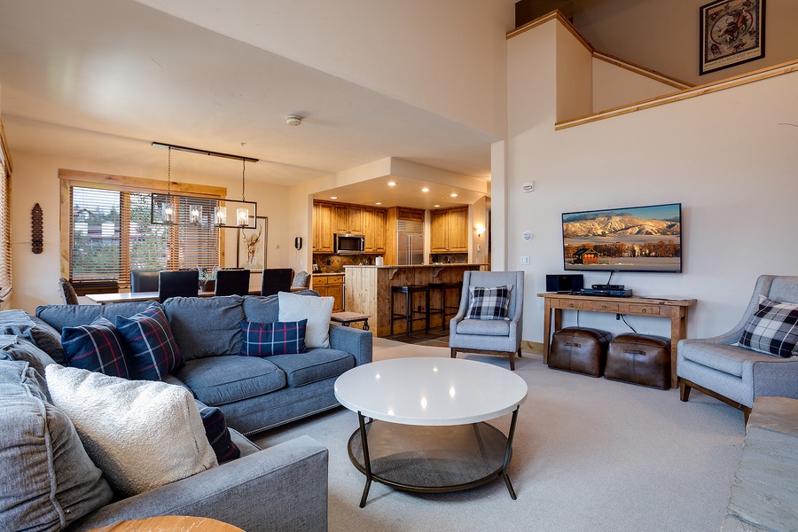 Sink into plush seating and unwind in your spacious living room, where mountain views on the big screen and an open kitchen invite effortless relaxation and togetherness.