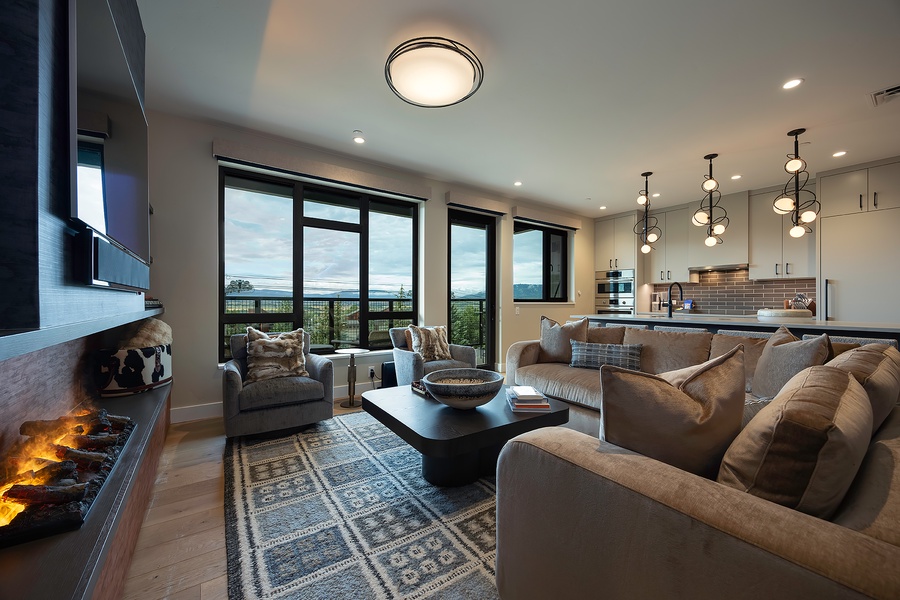 Sink into plush sofas by the fireplace and let the stunning landscape views through floor-to-ceiling windows become your favorite daily backdrop.