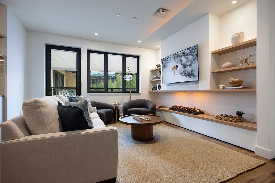 Sink into the plush seating and unwind in this thoughtfully designed living space, where natural light floods through large windows and modern built-ins create the perfect blend of comfort and style for your mountain getaway.