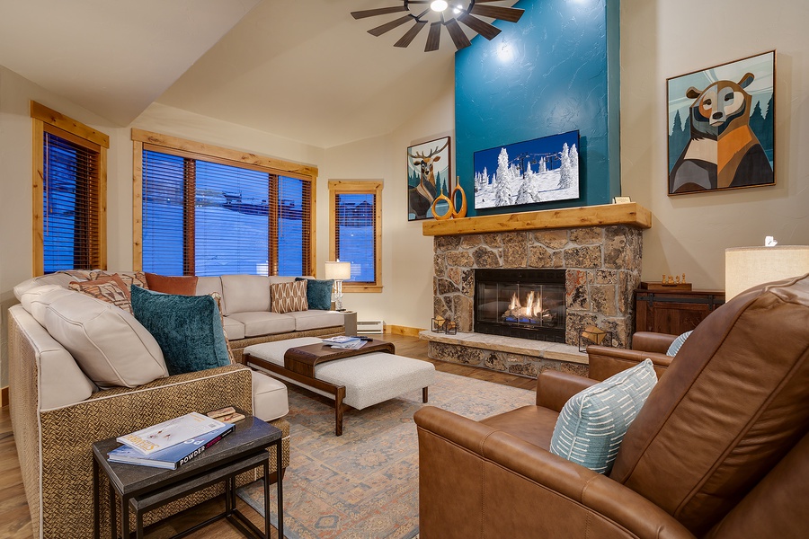 Settle into this inviting living room where your mountain retreat begins. Sink into plush seating by the stone fireplace, perfect for unwinding after your adventures on the slopes.