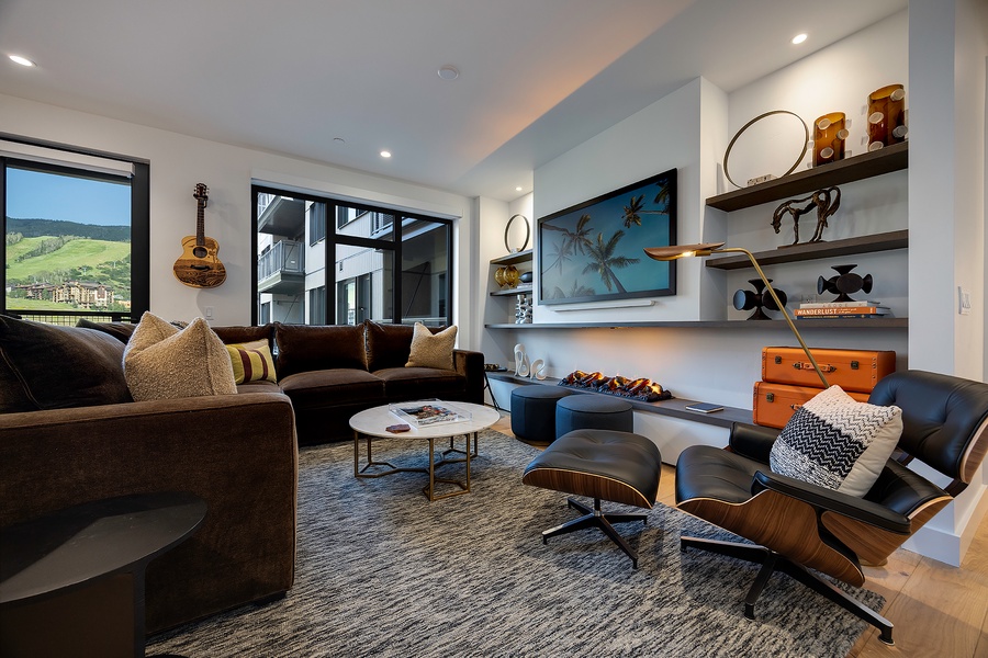 Sink into the plush sectional or curl up in the Eames lounge chair as natural light floods this inviting living space. Your mountain escape awaits with stylish comfort and thoughtful touches throughout.