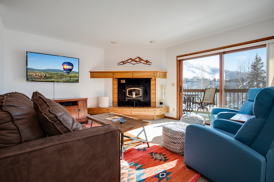 Sink into comfort with cozy seating, a warm fireplace, and stunning mountain views through your private balcony—perfect for unwinding after an adventure-filled day.