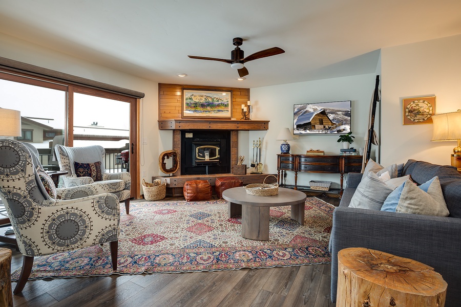 Curl up in your cozy living room with a warm fireplace, plush seating, and rustic mountain charm that makes every evening feel like home.