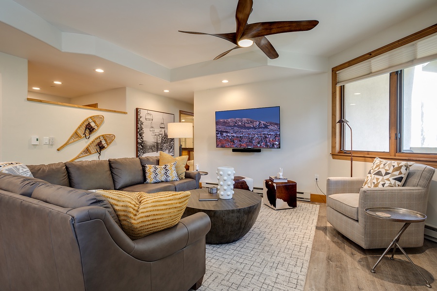 Sink into plush seating in your spacious living room, complete with a ceiling fan and mountain-view TV. Stylish decor and abundant natural light create the perfect retreat after your adventures.