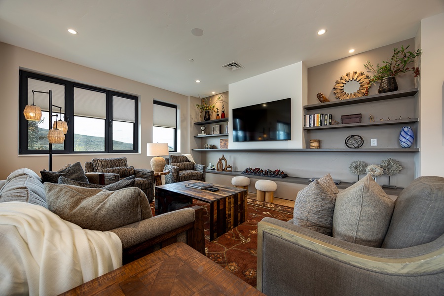 Sink into plush seating and let your worries melt away in this inviting living space, where natural light streams through picture windows and thoughtful decor creates the perfect retreat for your group.