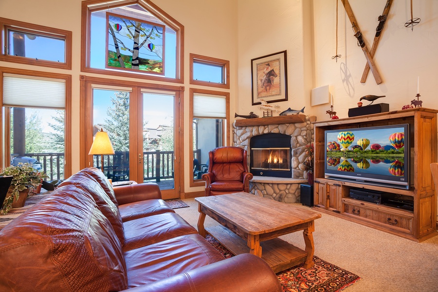 Sink into plush leather seating as you warm up by the stone fireplace, enjoy your favorite shows, and take in mountain views through soaring windows that fill the room with natural light.