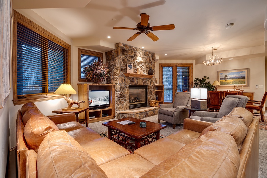Sink into plush leather sofas, feel the warmth of your stone fireplace, and unwind in this inviting living space designed for your comfort and relaxation.