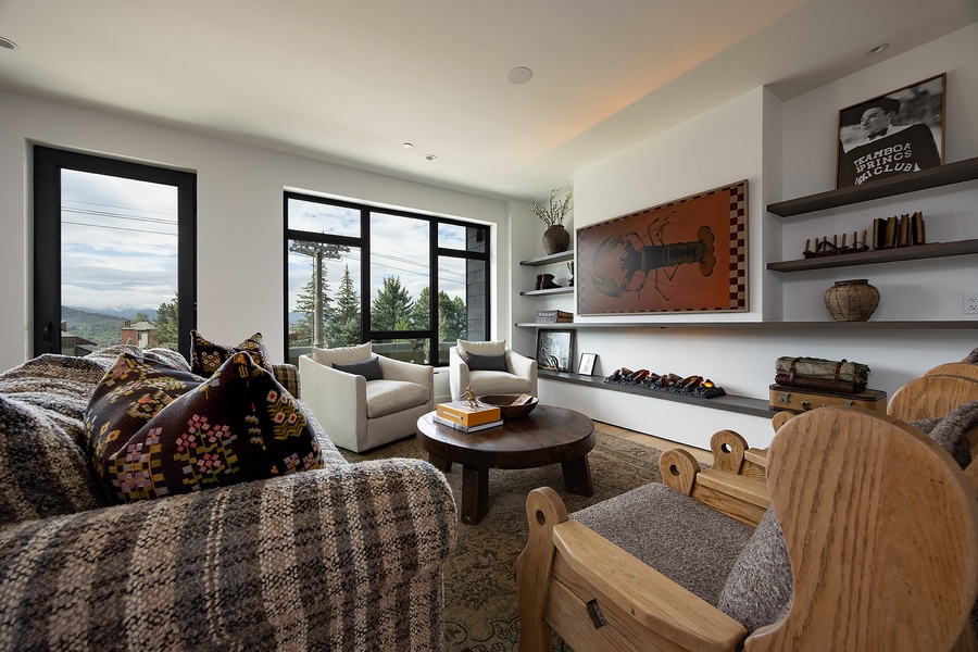 Sink into your private living area and enjoy mountain views through expansive windows. Warm textures, curated art, and thoughtful design create your perfect retreat.
