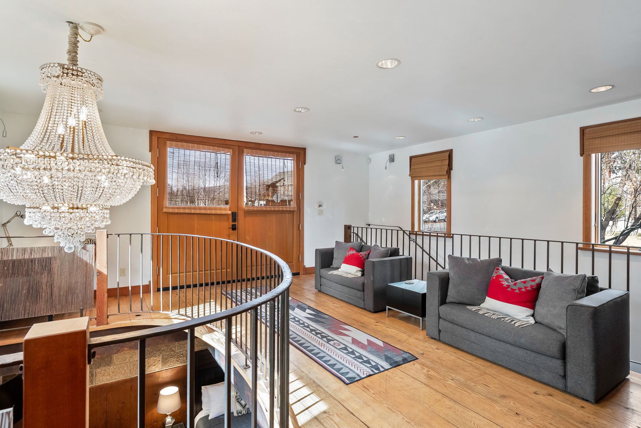 Unwind in your bright, airy living space with elegant chandeliers, plush sofas, and warm wood floors perfect for relaxing after a day of adventure.