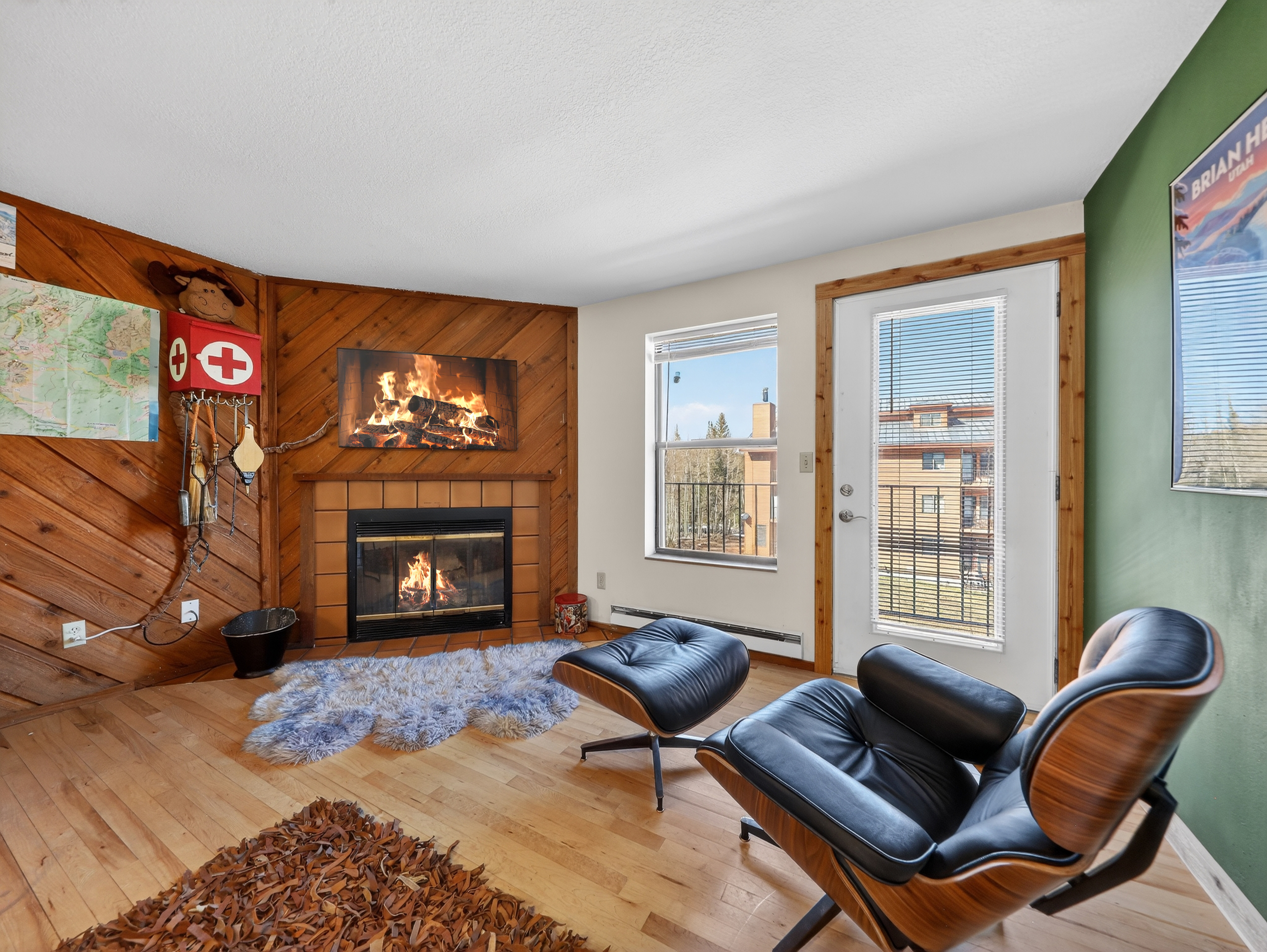 Cozy up in your ski chalet living room, where the crackling fireplace and iconic leather chair create the perfect après-ski retreat.