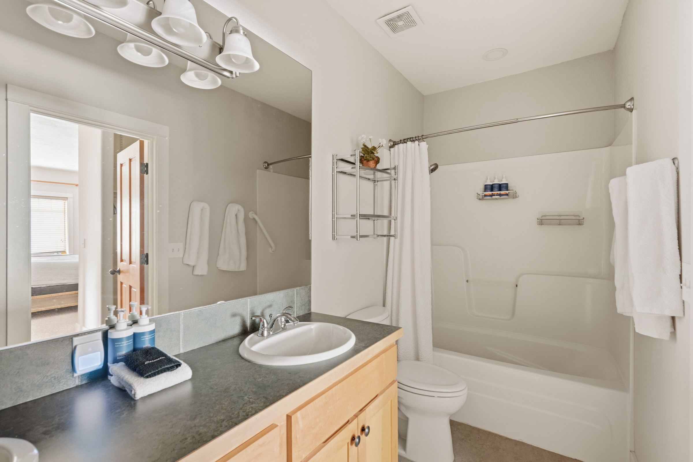 Your private bathroom features fresh towels, essential amenities, and a convenient shower-tub combo for relaxing after your adventures.