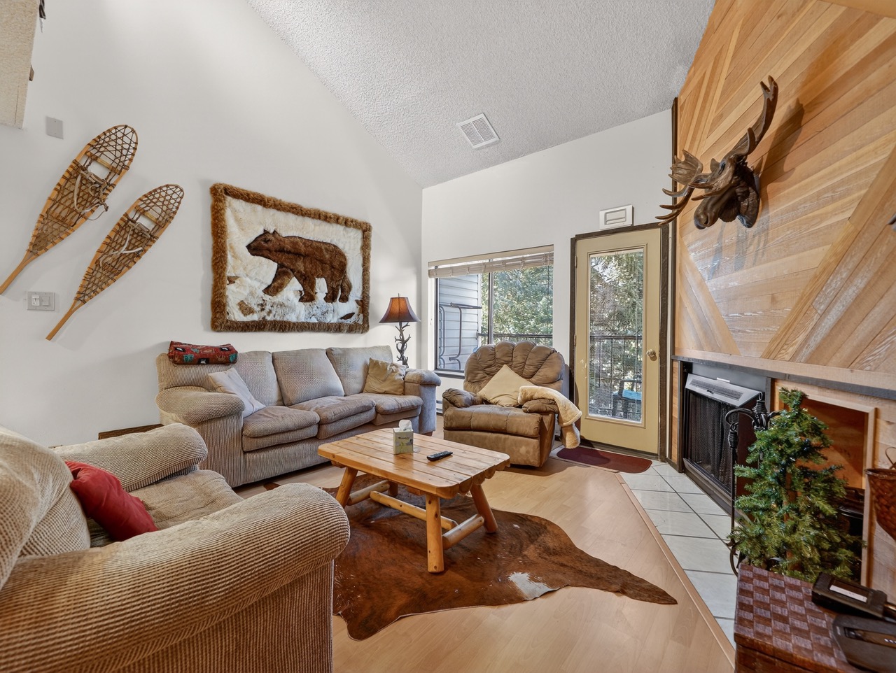 Sink into plush seating by your crackling fireplace, where rustic charm meets comfort in this cozy living room.