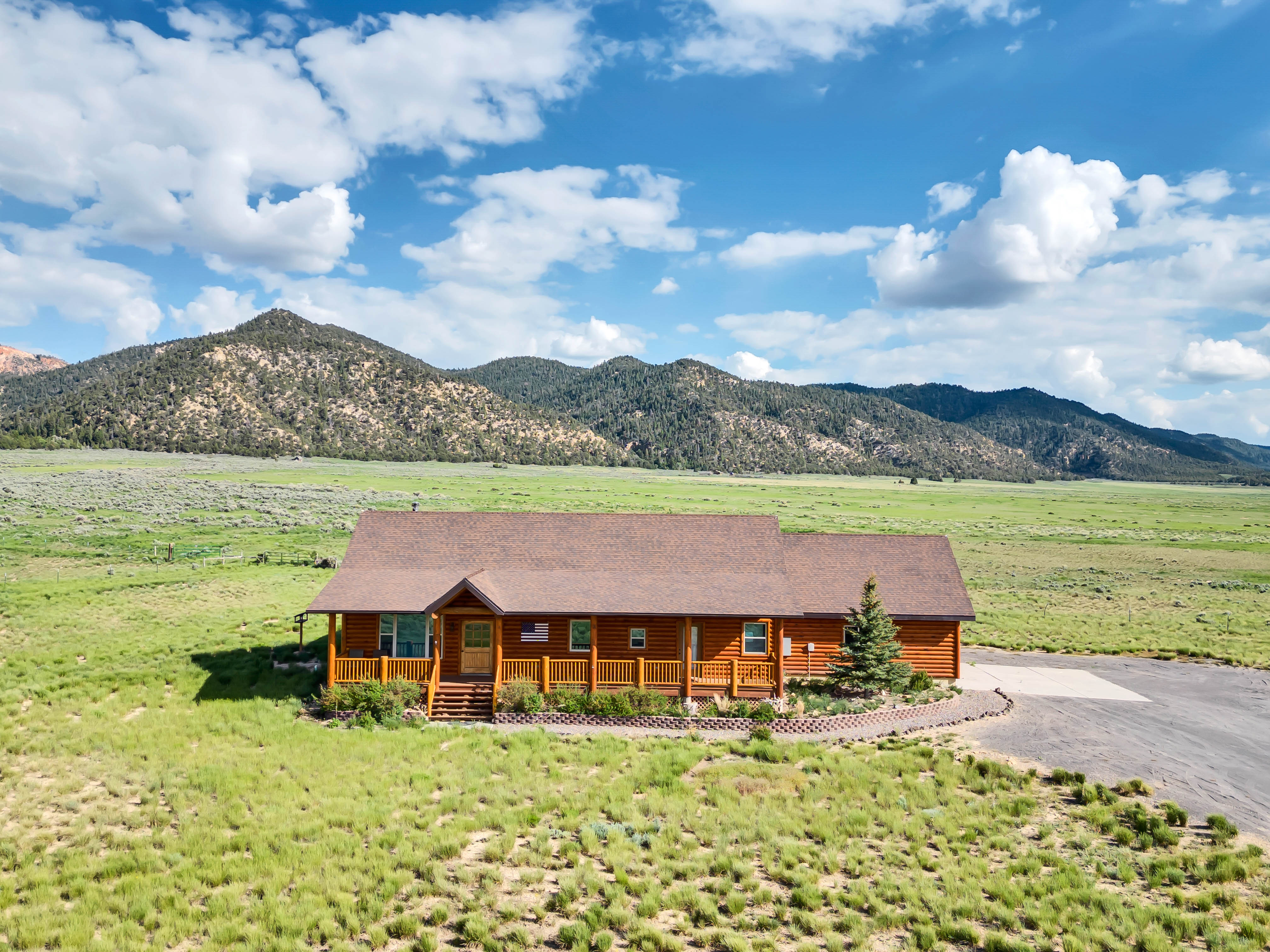 Exterior Retreat: Embrace stunning mountain views from this charming log cabin getaway!