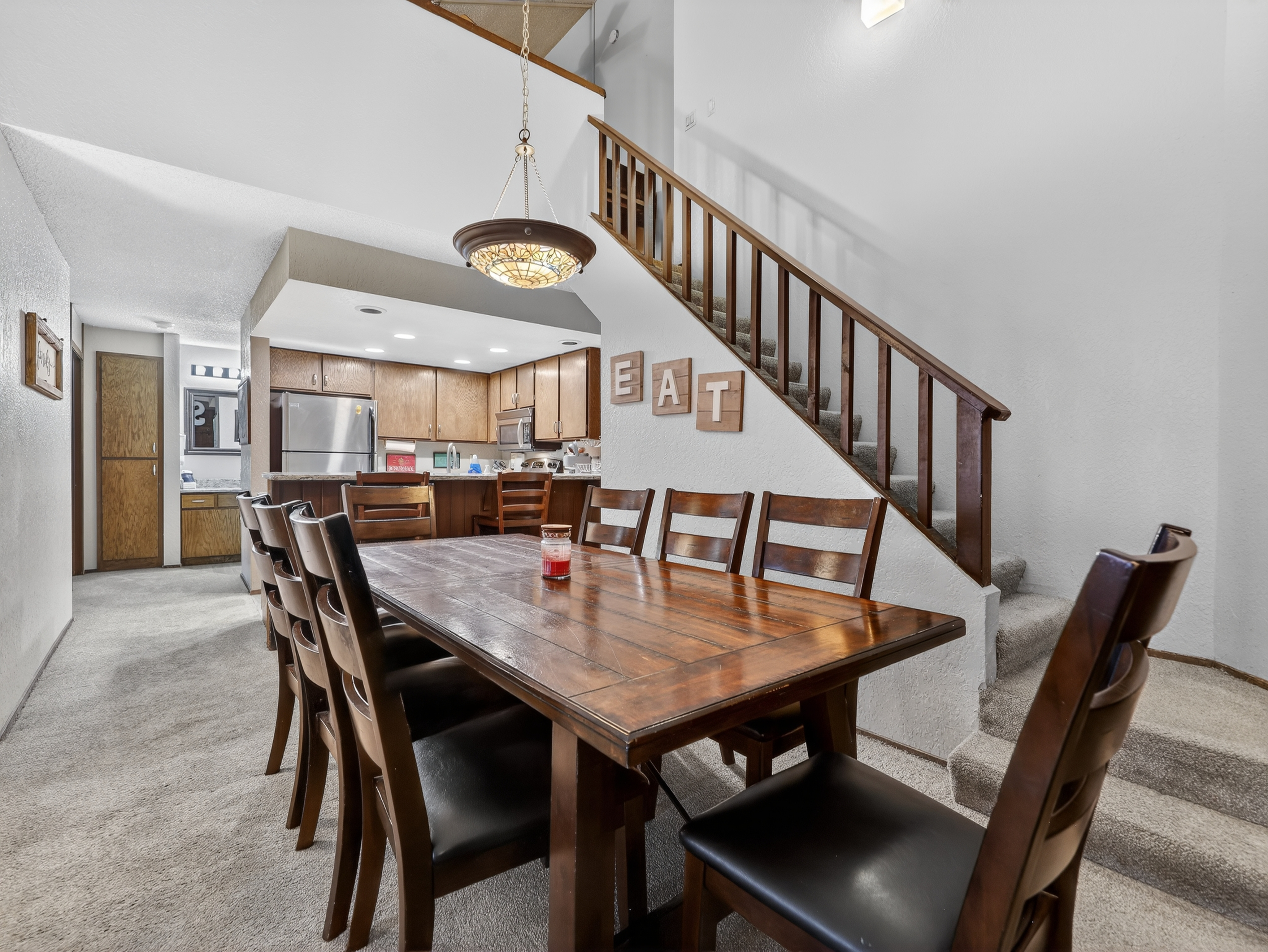 Gather your group around this spacious dining table for memorable meals, with a fully equipped kitchen ready for your culinary adventures.