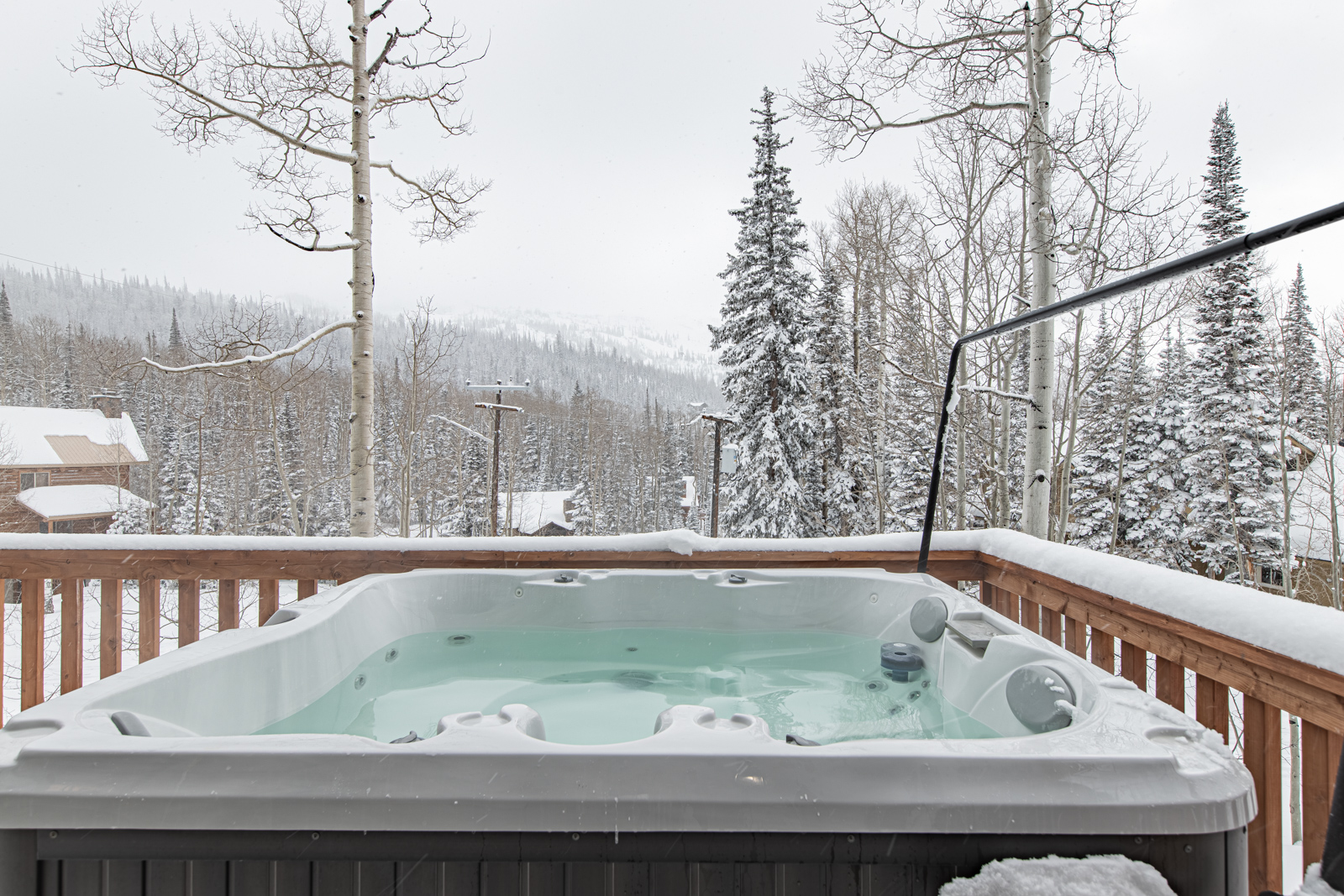 Hot Tub Retreat: Relax in the bubbling warmth as you soak in stunning snowy mountain views!