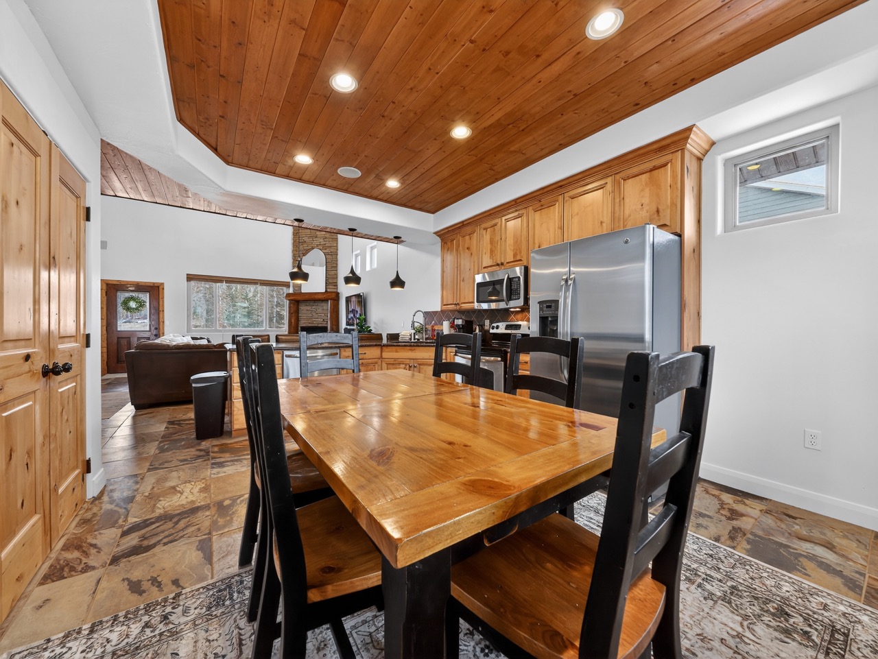Your mountain retreat features a stunning wood-beamed ceiling, granite island, and spacious dining table where memorable meals await your family.