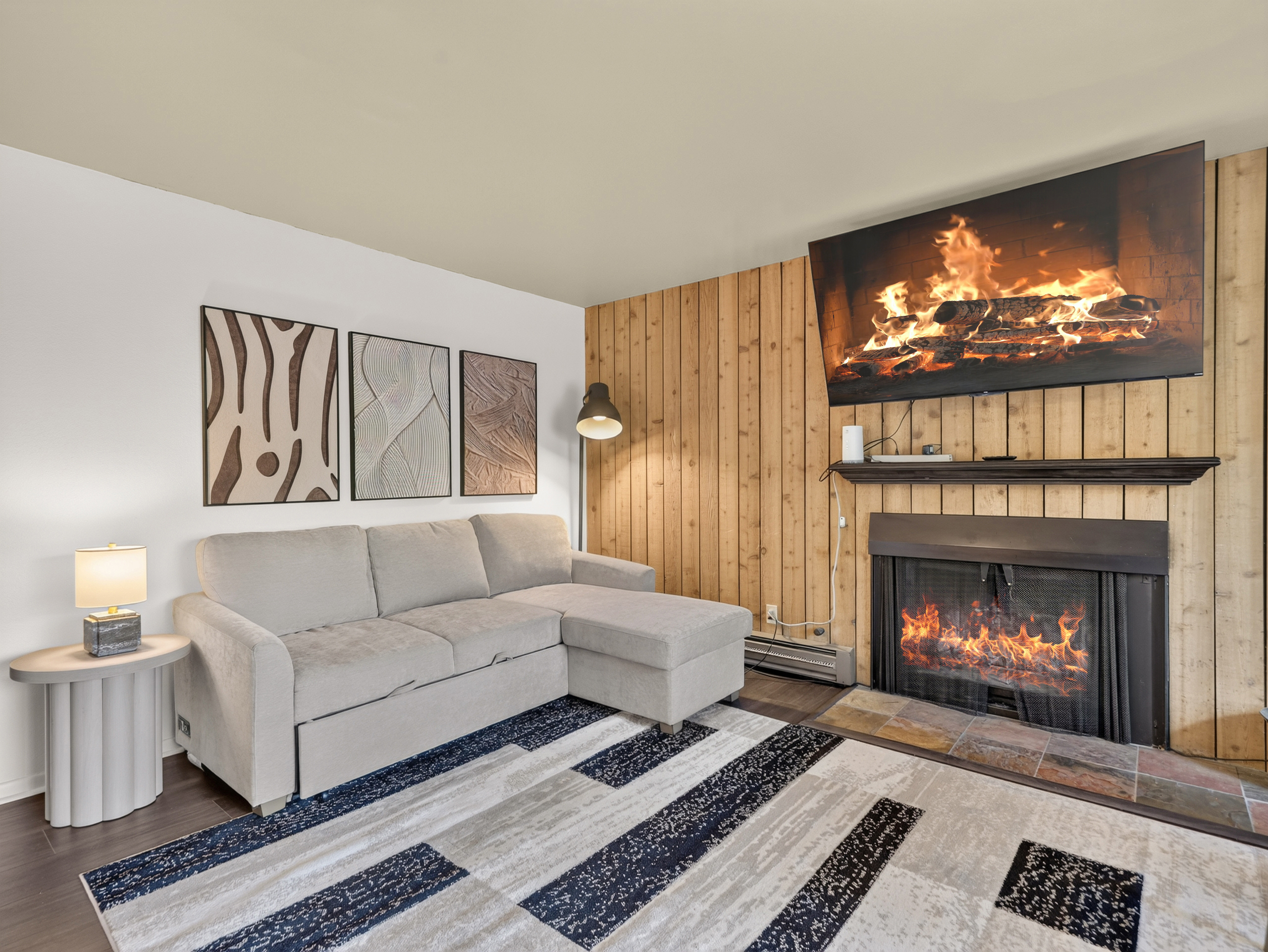 Settle into the plush sofa and let the warmth of the fireplace embrace you after a day of mountain adventures—a cozy retreat designed for relaxation.