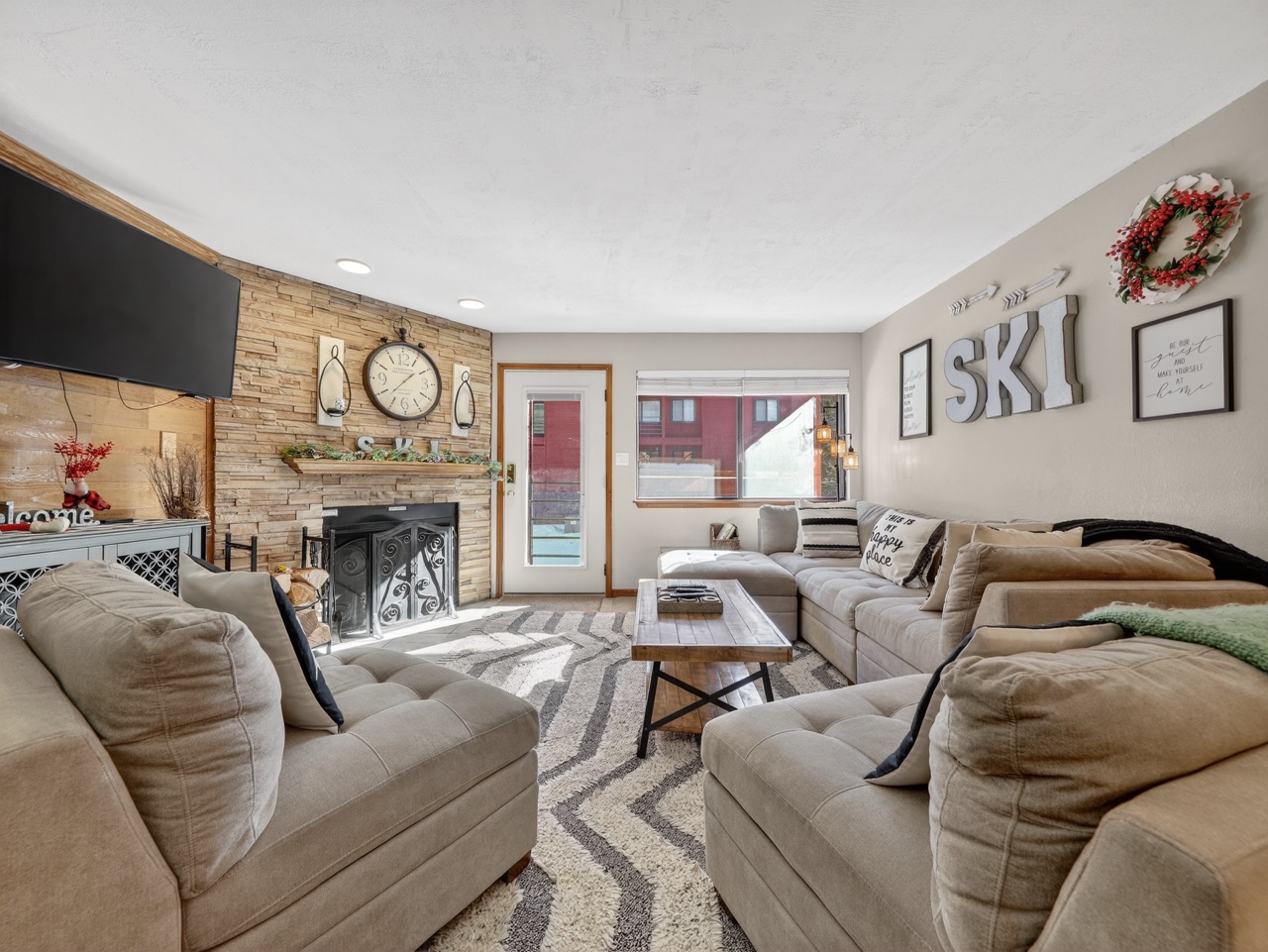 Sink into plush sofas by your cozy stone fireplace, where mountain-themed décor creates the perfect après-ski atmosphere for relaxing evenings.