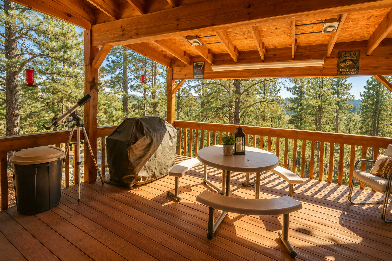 Step onto your covered deck, where benches and a table await beneath stunning exposed beams. Gaze out at the forested hillside as sunlight filters through the pines, creating the perfect spot to unwind.