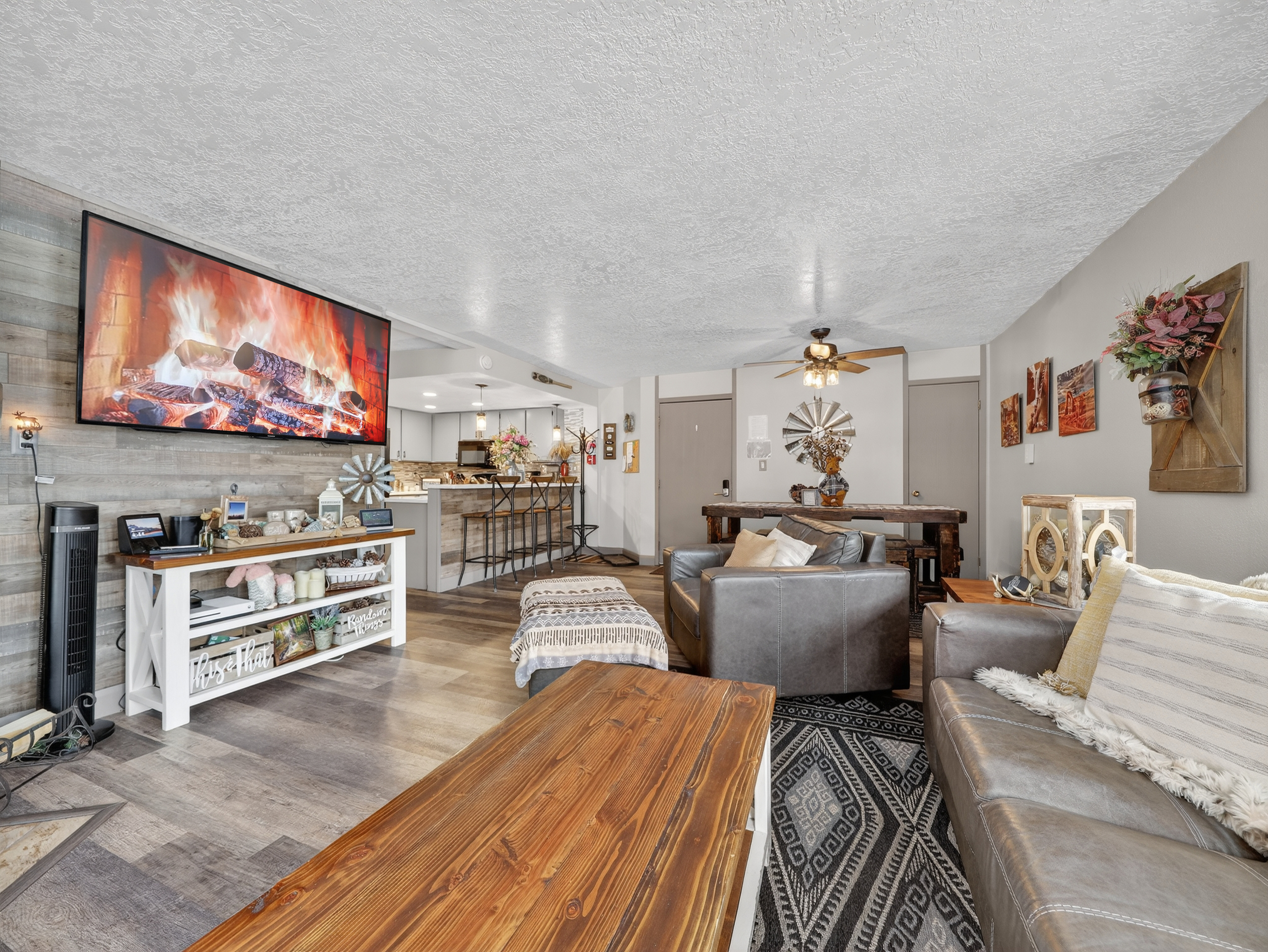 Cozy up in your stylish living space with a warm fireplace, flat-screen TV, and comfortable seating perfect for relaxing evenings.