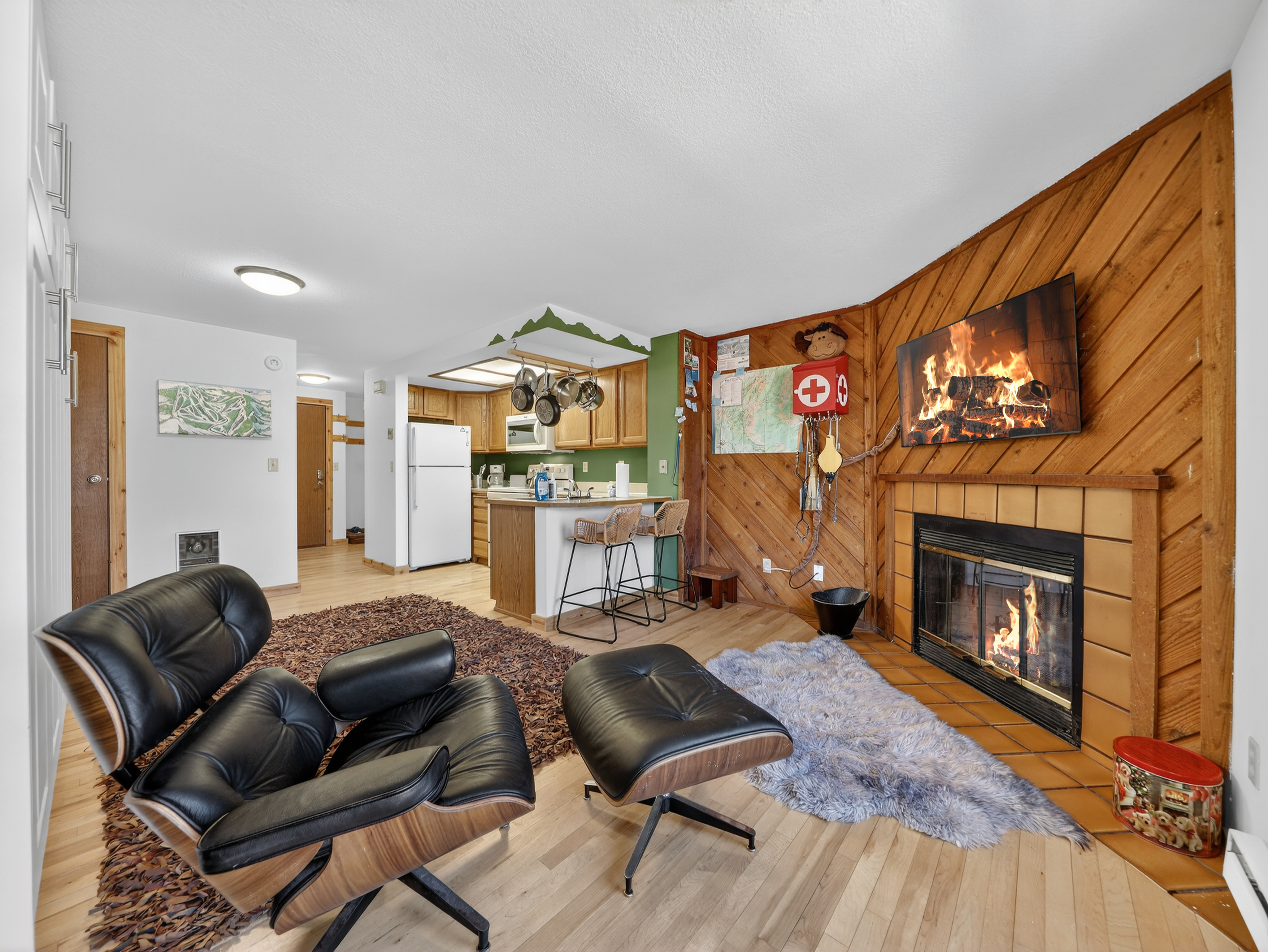 Cozy up in your leather lounge chair by the crackling fireplace while enjoying the open kitchen and rustic wood accents.