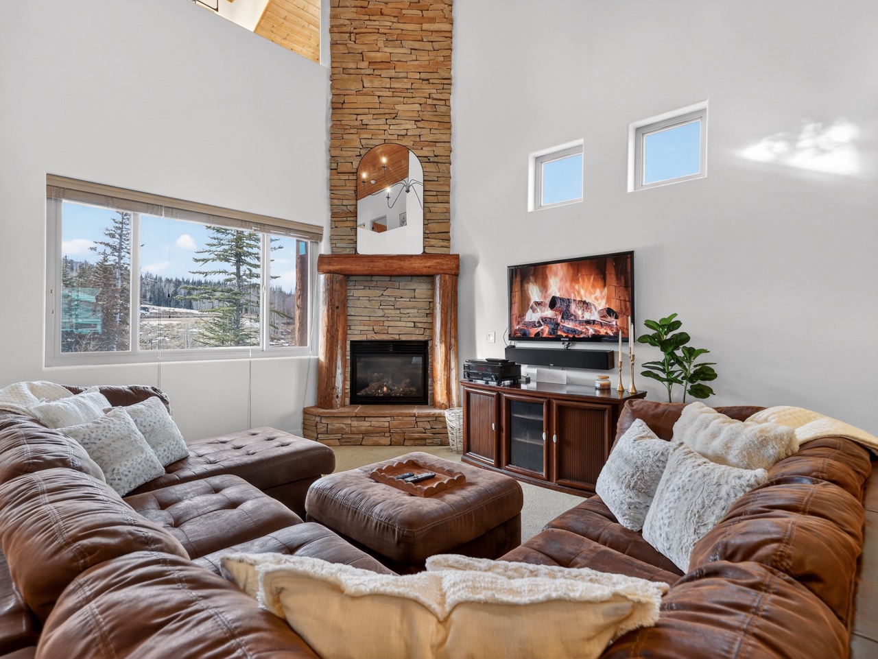 Sink into plush leather sofas by your stone fireplace while mountain views frame perfect relaxation moments.