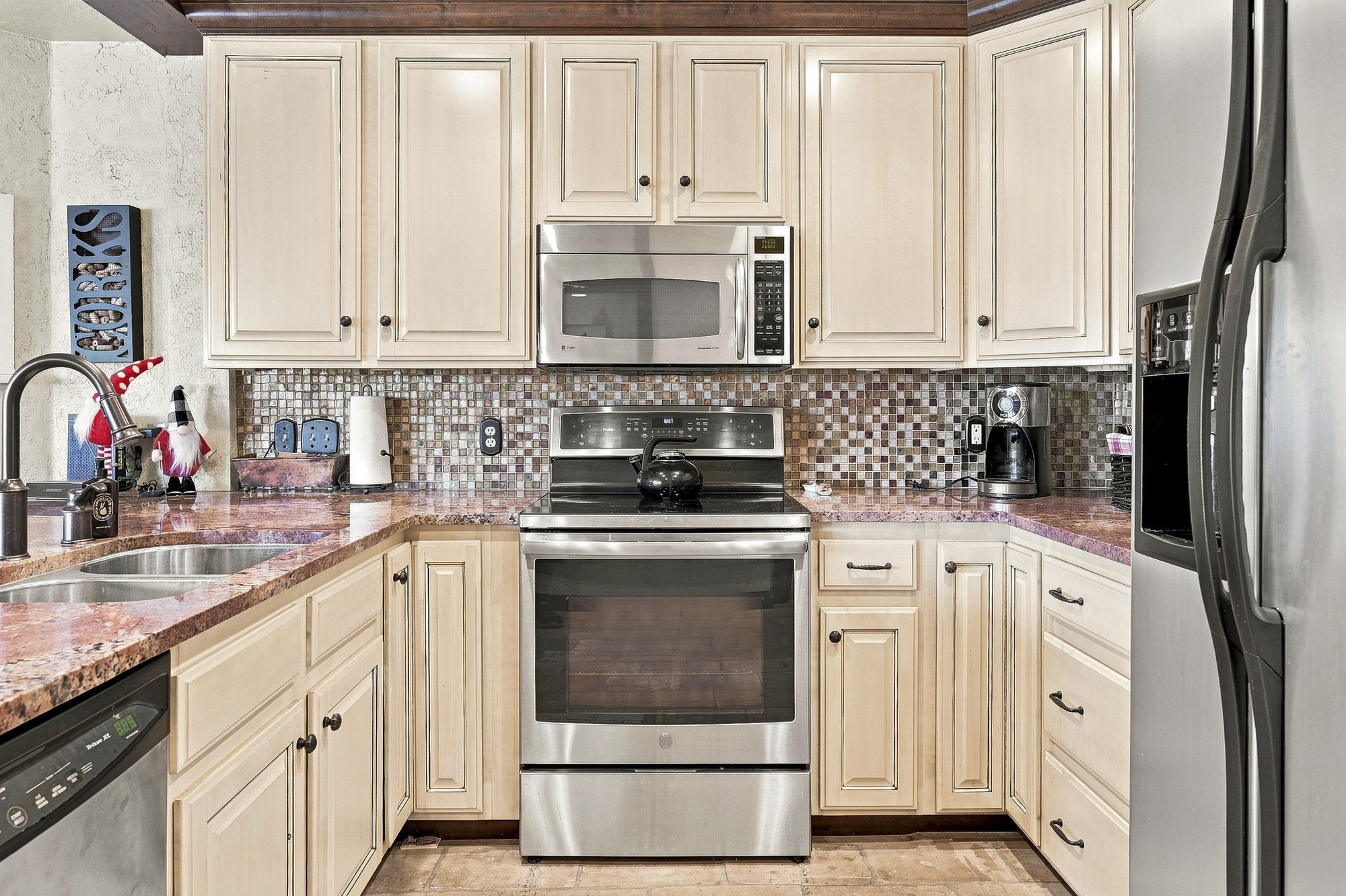 Step into your fully equipped kitchen with modern appliances, granite countertops, and a cheerful mosaic backsplash. Everything you need to whip up a quick breakfast or a full holiday meal.
