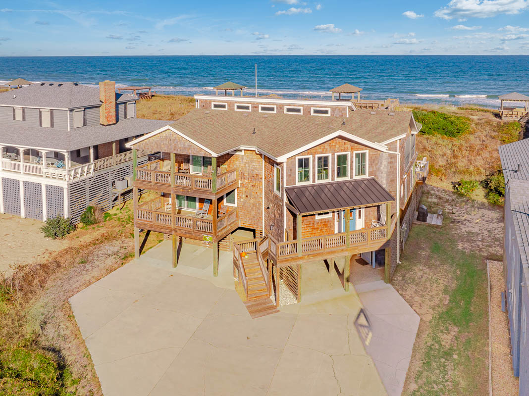 Oceanfront beach house with elevated design and direct beach access, featuring natural surroundings and coastal architecture.