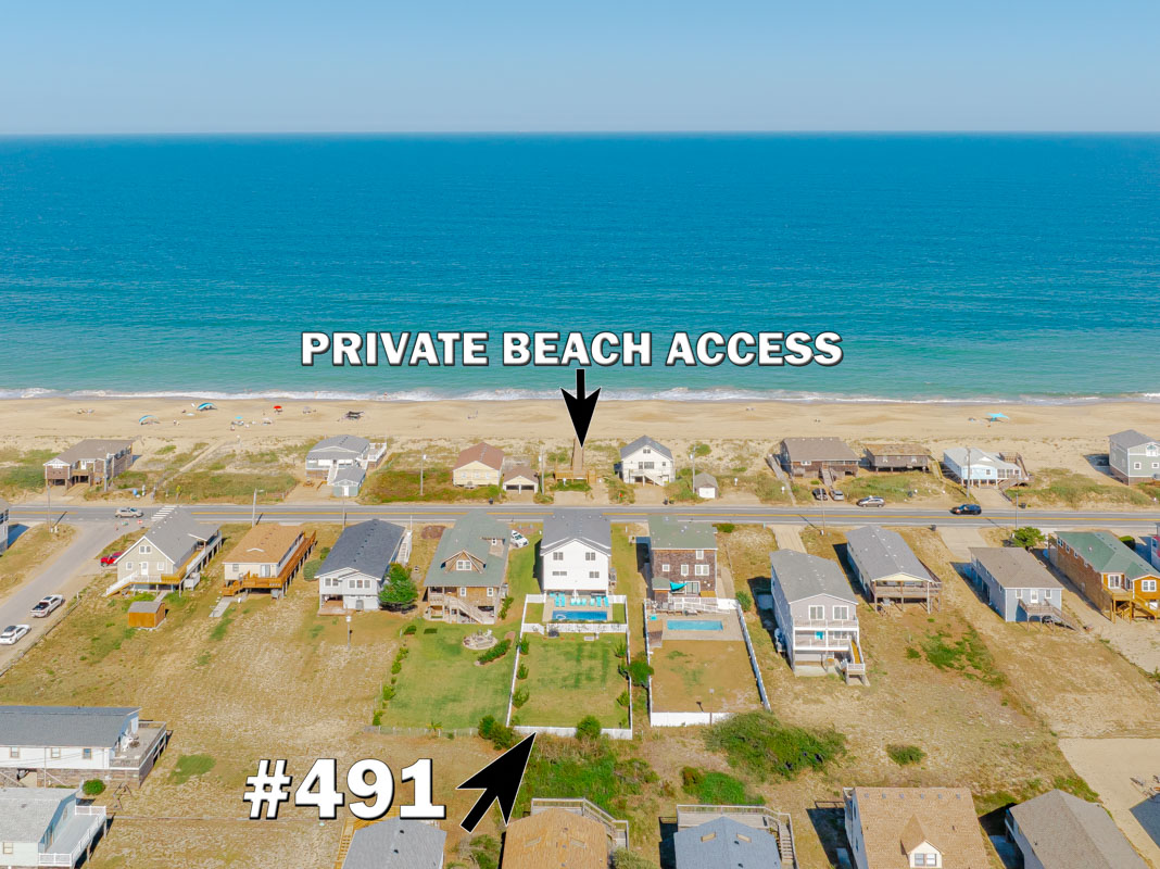Beachfront property with private beach access steps from pristine sandy shores and turquoise waters.