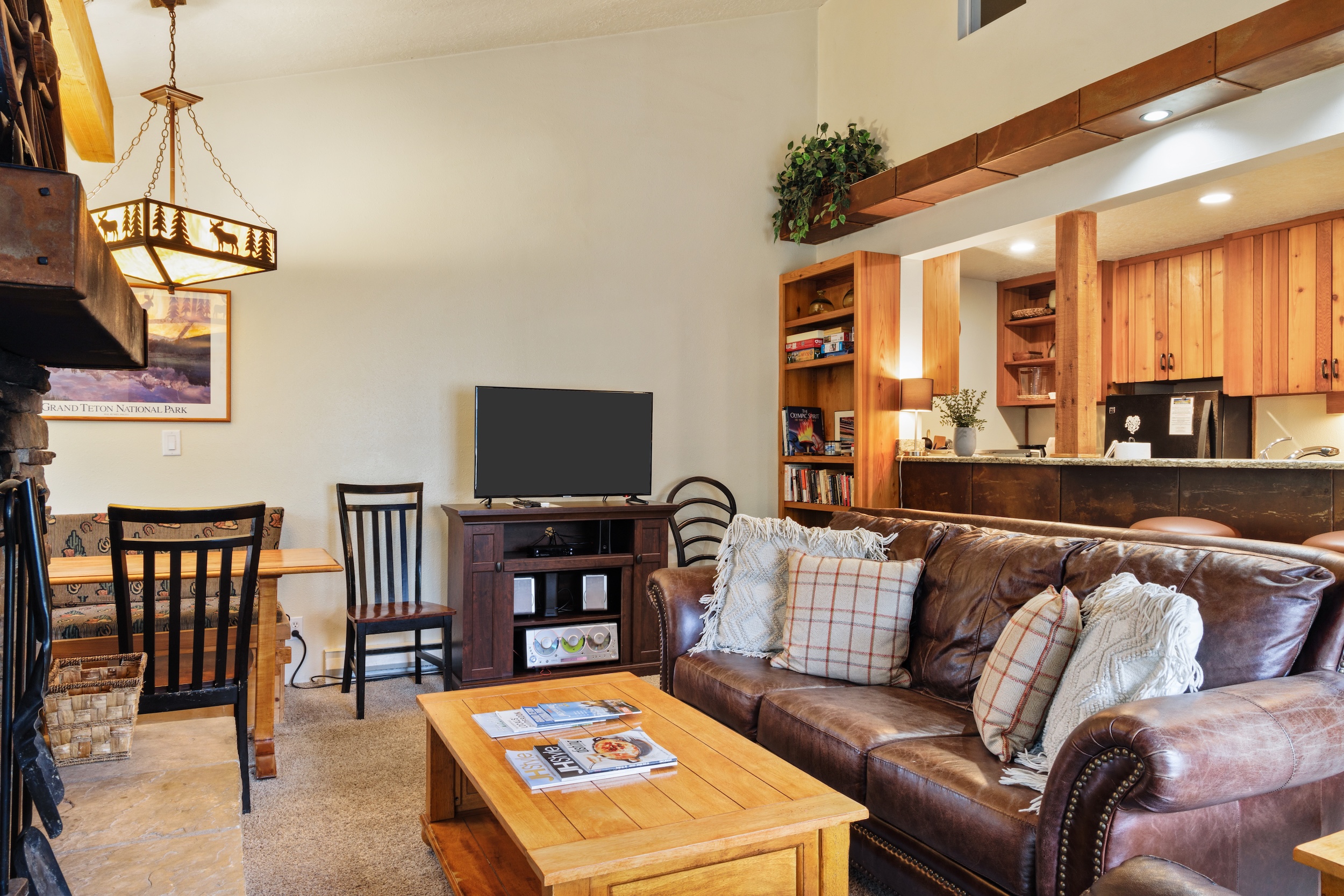 Sink into the plush leather sofa and unwind in this warm, open-concept living space. Rich wood tones, soft lighting, and thoughtful touches create a cozy retreat where you can relax after a day of adventure.