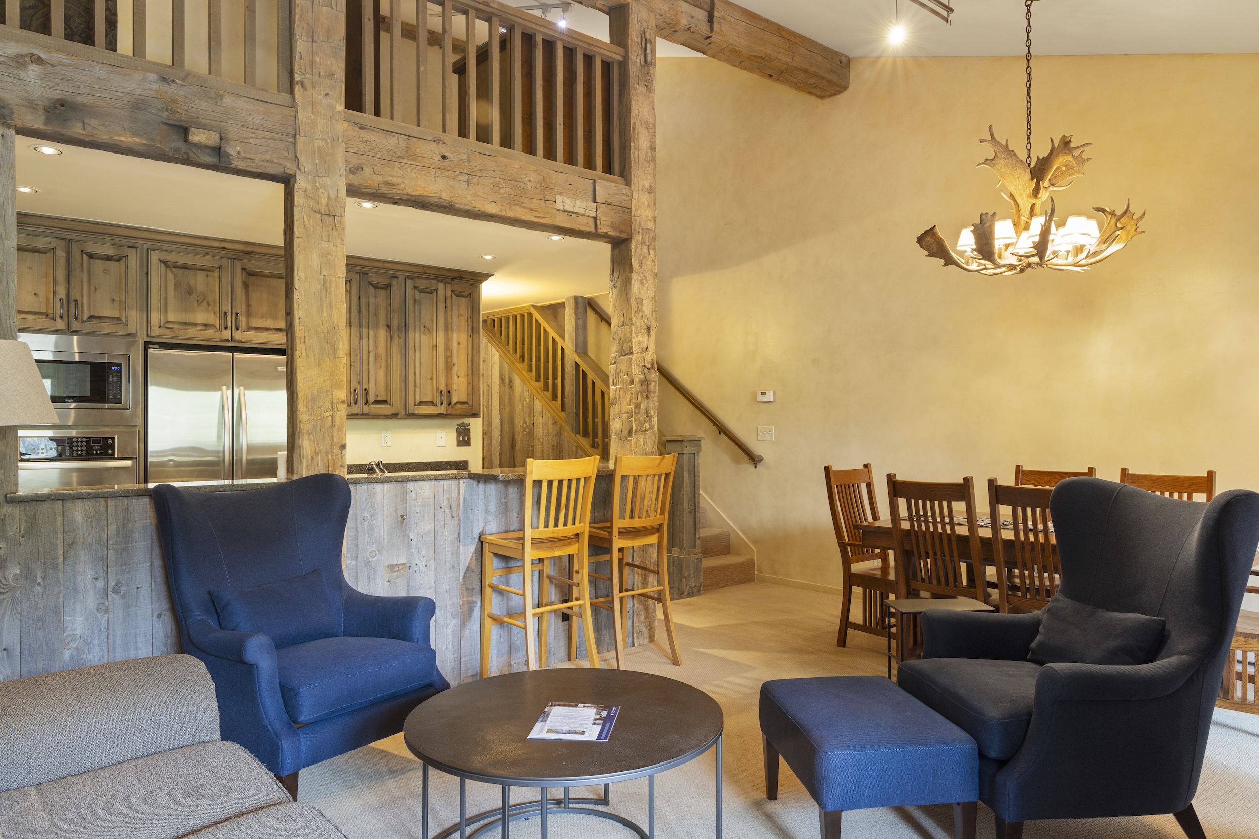 Unwind in your open-plan living space with soaring timber beams, a cozy breakfast bar, and rustic-modern touches that invite you to relax and gather with loved ones.