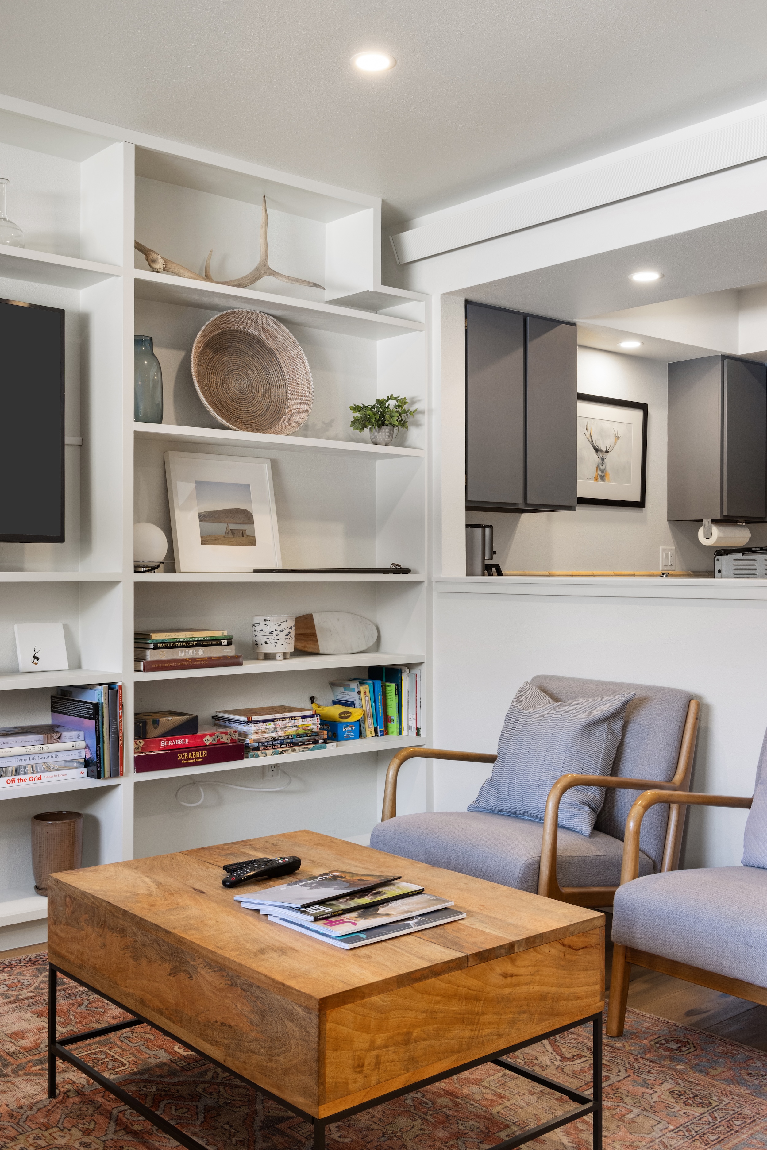 Curl up in your cozy reading nook with built-in shelves and modern furnishings for perfect relaxation.