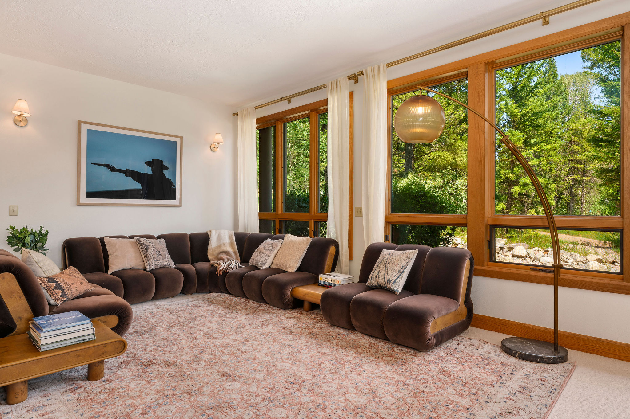 Sink into plush seating and let the lush garden views through expansive windows invite peaceful moments into your stay.