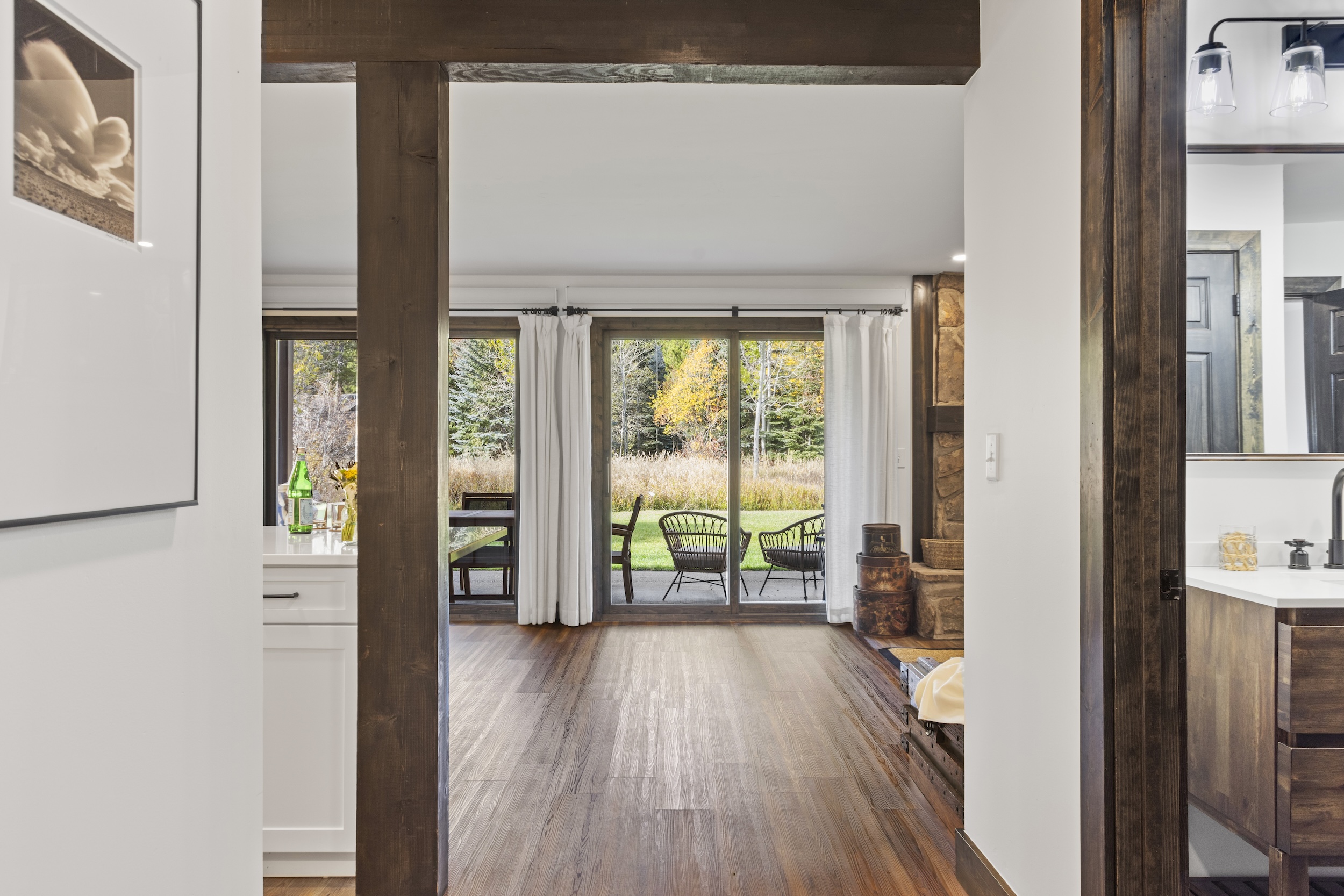 Entrance hallway opens into great room with outdoor views