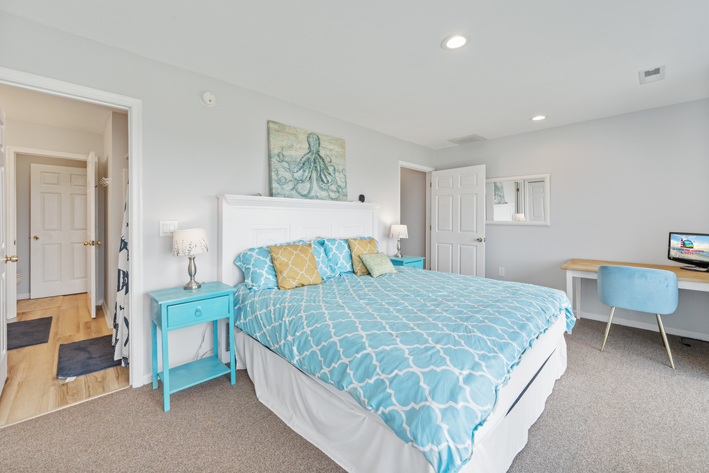On the 2nd Floor, you'll find the Primary Bedroom with a Queen Bed and colors of sea glass.