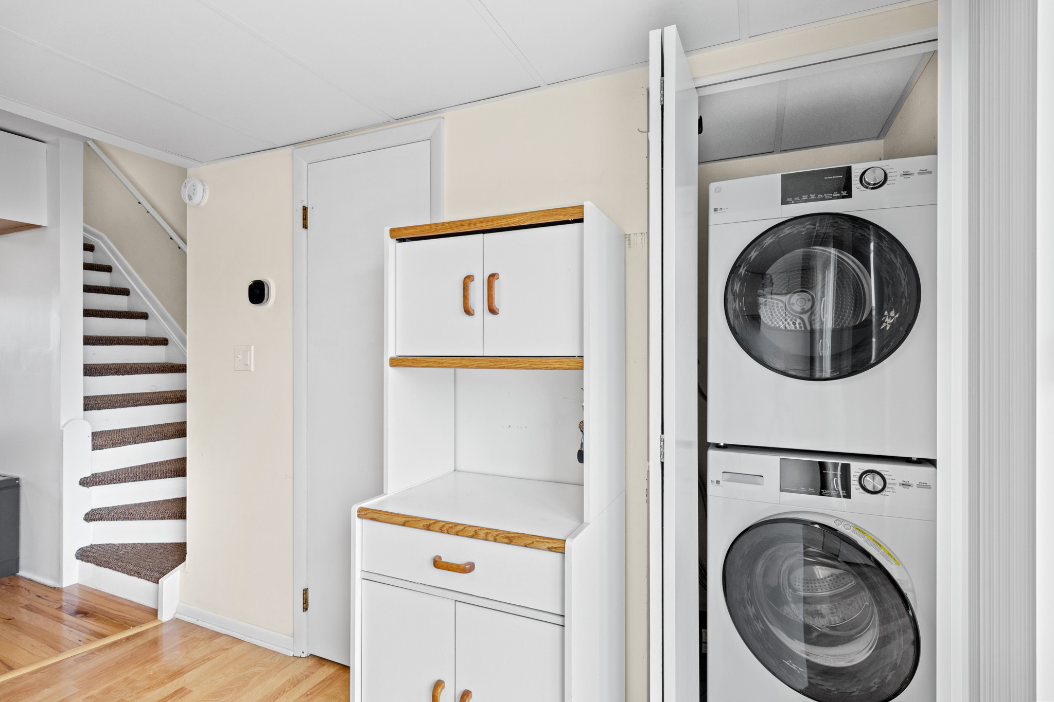 The kitchen is also home to the convenient Stacked Washer and Dryer!