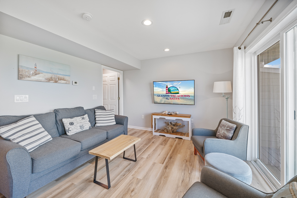 Relax in the Living Area with comfy furnishings, Free WiFi, and Flat Screen Smart TV.