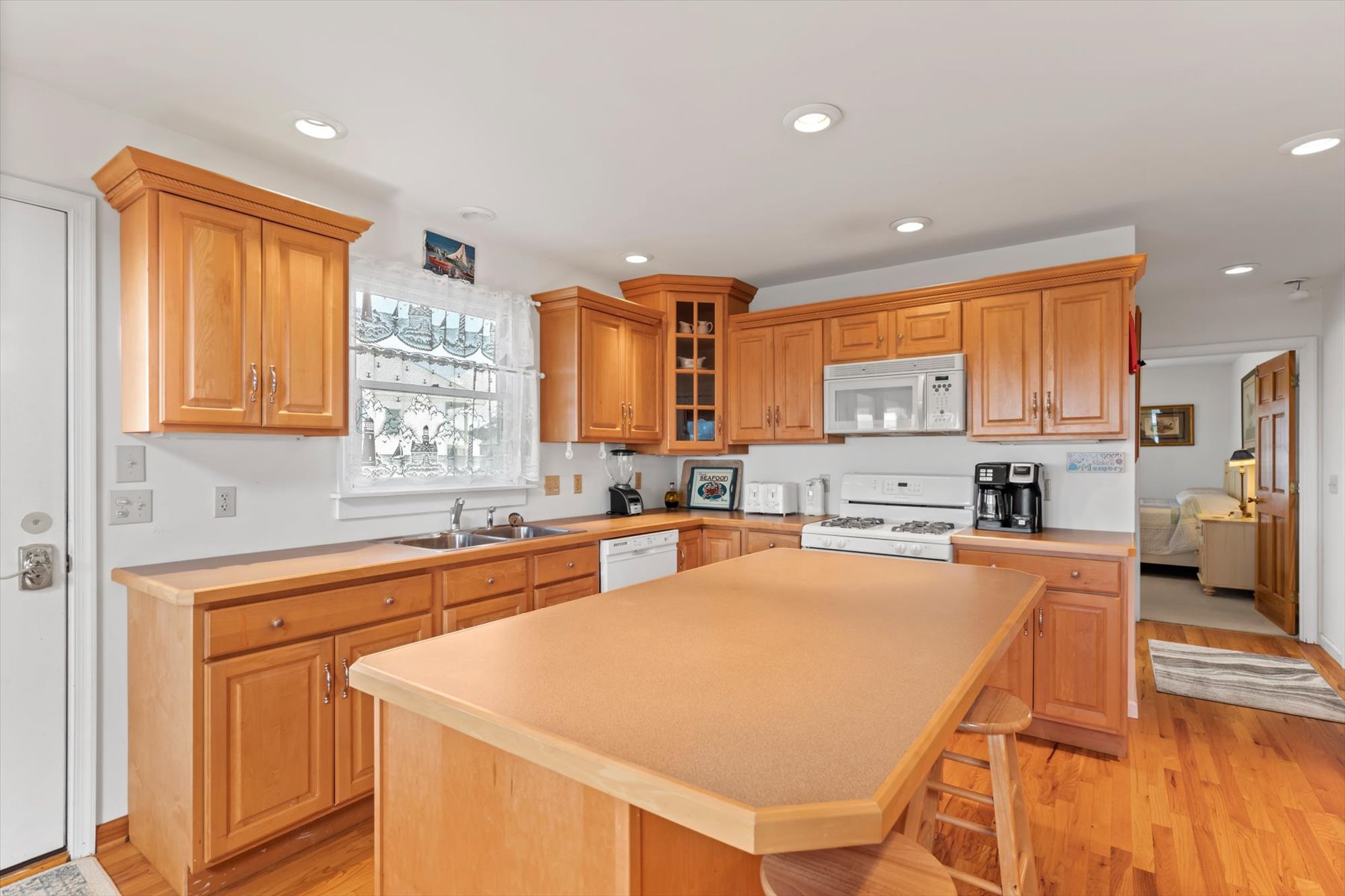 Plenty of room between the Island and large Dining Table.