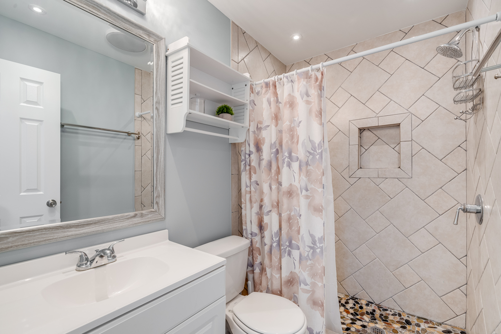 Upstairs full bath with custom tile walk-in shower.