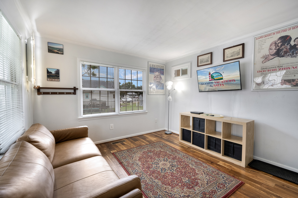 The Family Room lines the back of the home, and has another Flat Screen Smart TV and Seating Area.