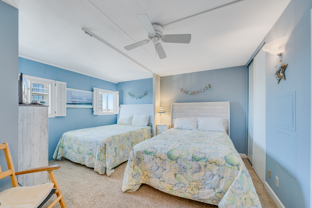 The bedroom has 2 Comfy Queen Beds!