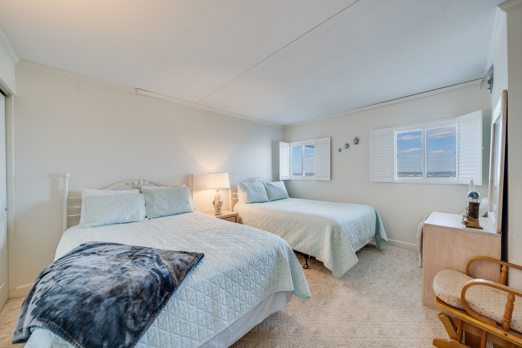 The bedroom features 2 Queen Beds!