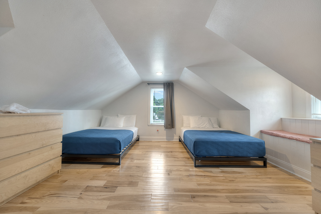 Bedroom 2 has 2 Queen Beds and beachy blue bedding.