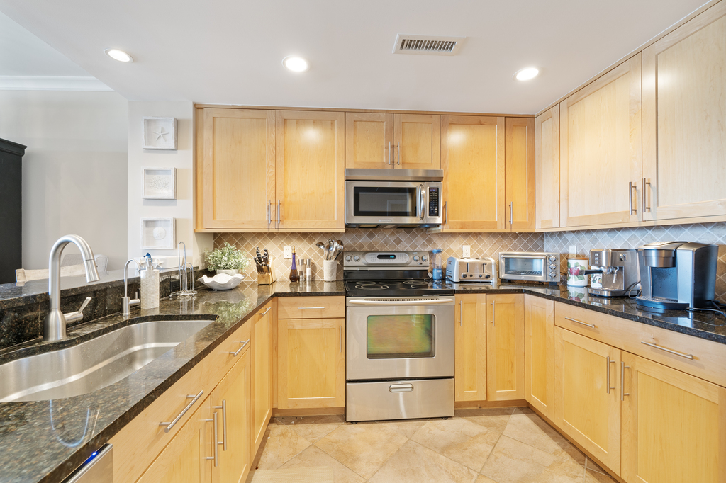 Gleaming Granite Countertops and Warm Wood are beautiful and inviting.