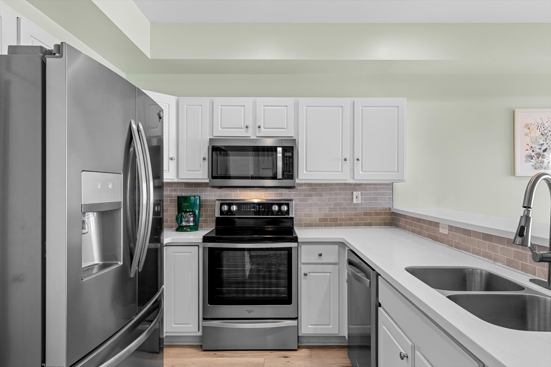 Beachy White Cabinetry and Stainless Steel Appliances.