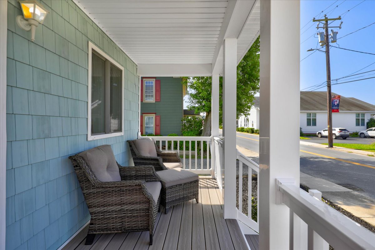 Covered Front Porch has comfy Chairs to relax in.